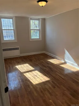 a view of wooden floor and windows in a room