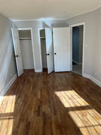 a view of an empty room and wooden floor