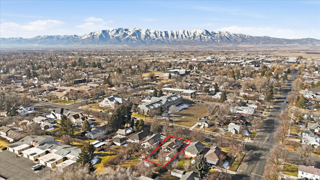 380 North 200 West Logan, UT 84321 - Photo 26 of 29 Aerial perspective of suburban area with mountains and property parcel outlined