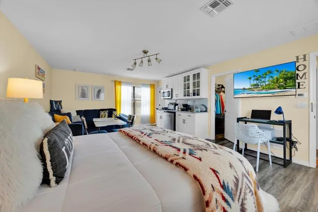 a bed room with a bed window and a chair