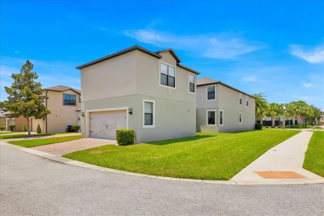 a view of a house with a yard and garage