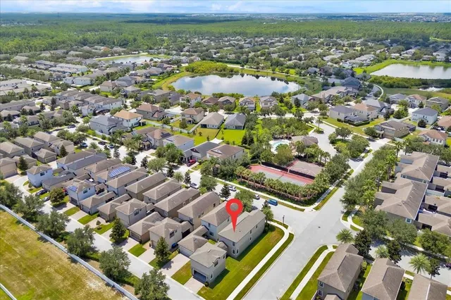 an aerial view of residential houses with outdoor space