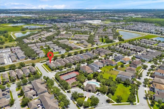 an aerial view of residential houses with outdoor space and river