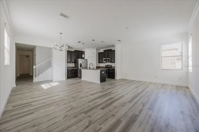 a view of a kitchen with a sink and a refrigerator