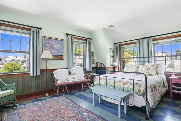 a bedroom with a bed a table and chair