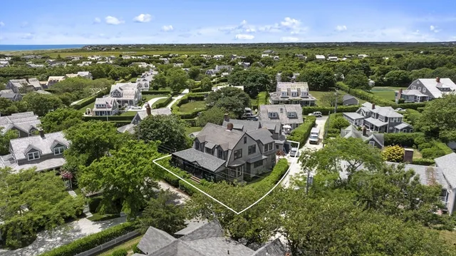 an aerial view of residential houses with outdoor space and swimming pool