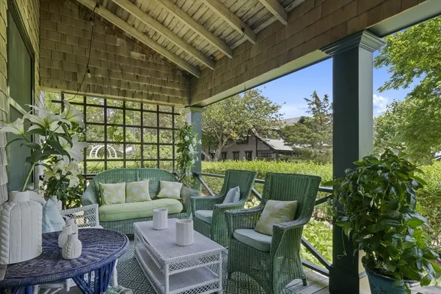 a roof deck with couches and potted plants