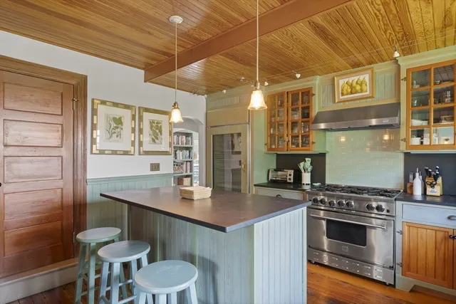 a kitchen with a sink cabinets and wooden floor