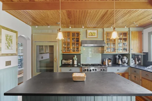 a kitchen with a sink and living room