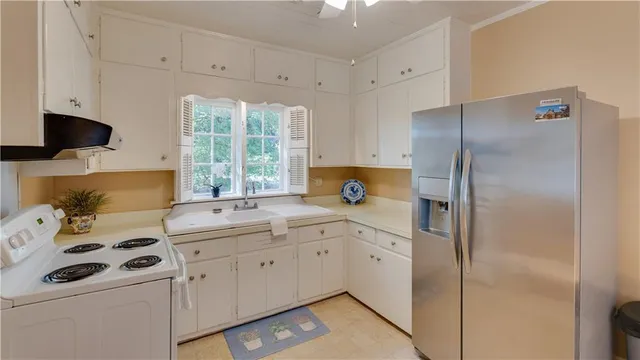 a kitchen with a sink cabinets and appliances
