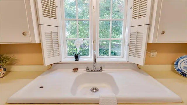 a bathroom with a bathtub and a window
