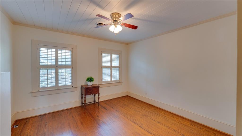 803 Forrest Avenue Tifton, GA 31794 - Photo 16 of 52 an empty room with wooden floor and windows