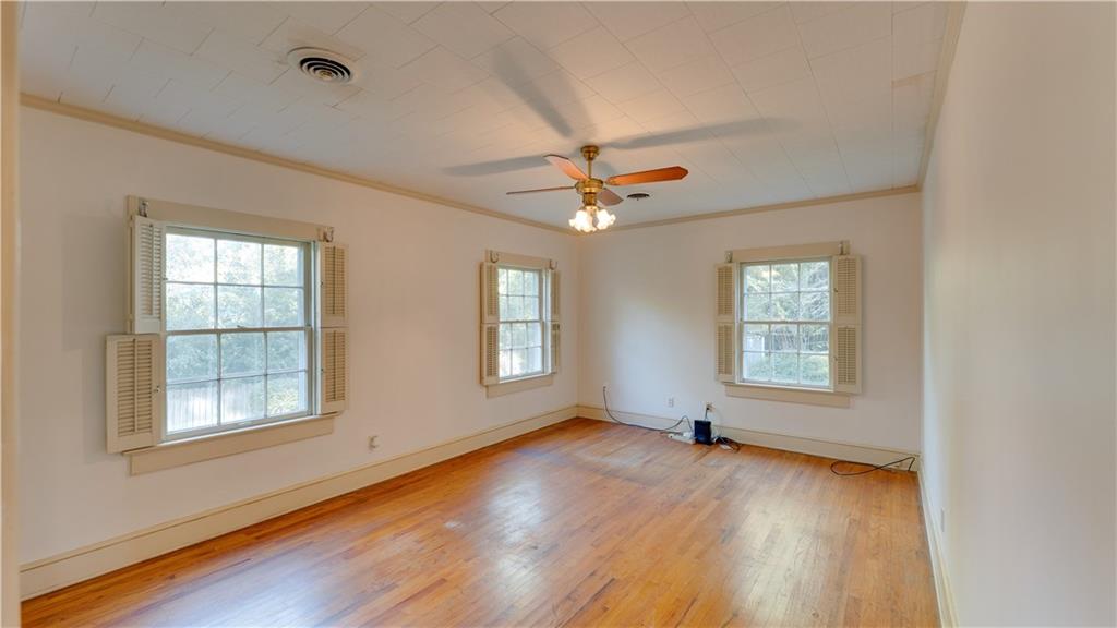 803 Forrest Avenue Tifton, GA 31794 - Photo 19 of 52 a view of an empty room with a window and wooden floor