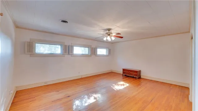 a view of a room with wooden floor and window