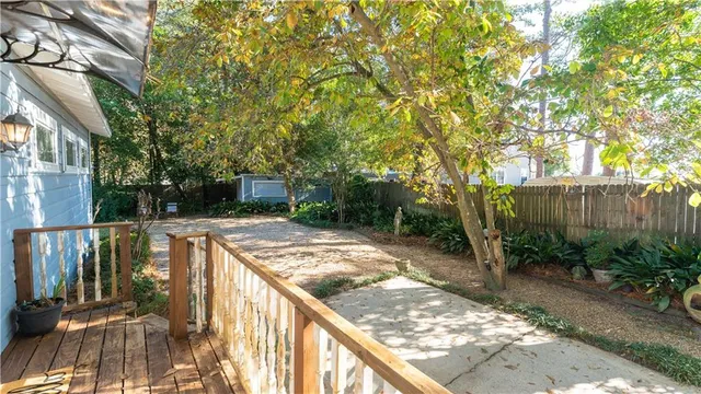 a view of balcony with wooden floor and fence