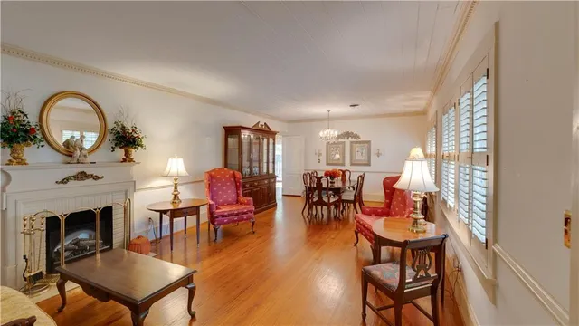 a living room with furniture a fireplace and a window