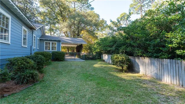 a view of backyard of house with green space