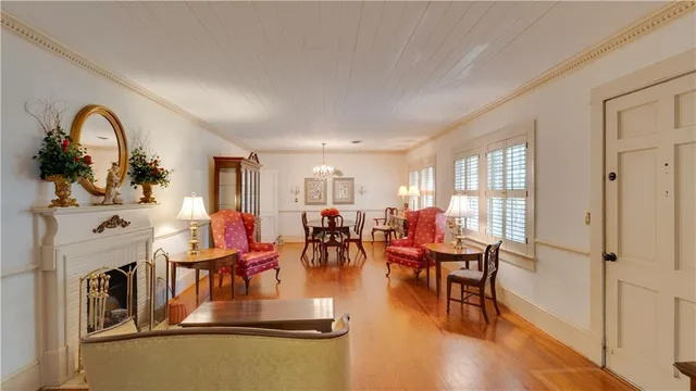 a living room with fireplace furniture and a large window