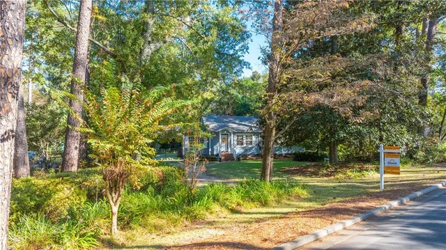 a view of a house with a yard porch and sitting area