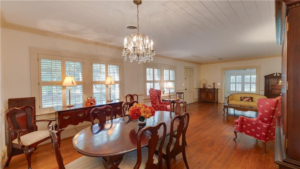 803 Forrest Avenue Tifton, GA 31794 - Photo 7 of 52 a view of a dining room with furniture a chandelier and large windows