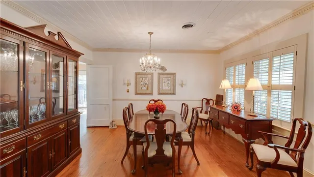 a dining room with furniture window and wooden floor