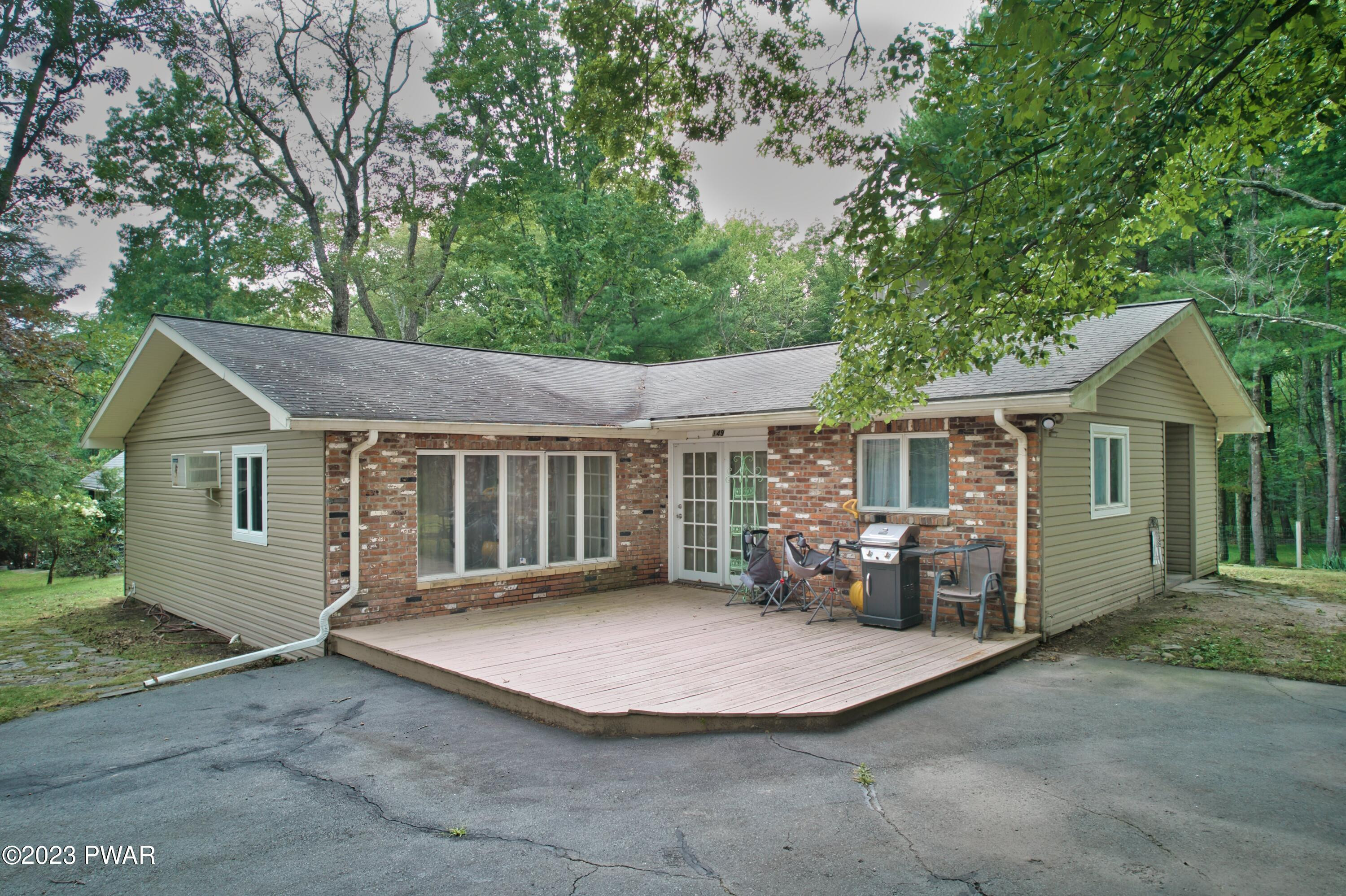 149 Walker Lake Road Shohola, PA 18458 - Photo 1 of 51 a view of a house with a yard and large trees