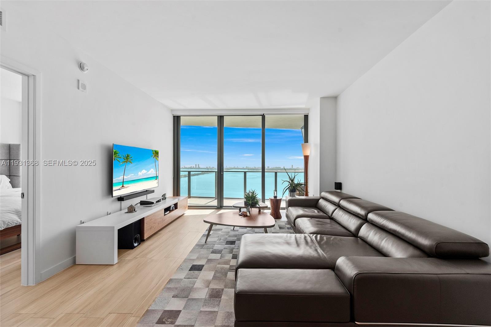 460 Northeast 28th Street, Unit 3903 Miami, FL 33137 - Photo 12 of 44 a living room with furniture and a flat screen tv