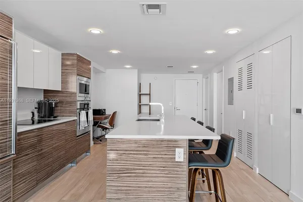 a view of kitchen with cabinets and wooden floor