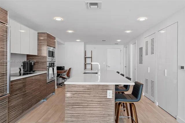 a view of kitchen with cabinets and wooden floor