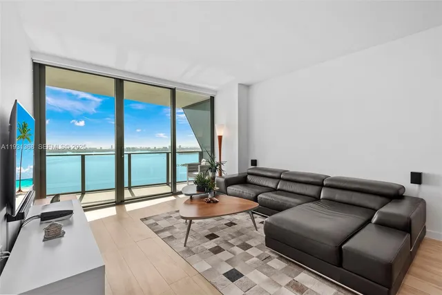 a living room with furniture and a large window