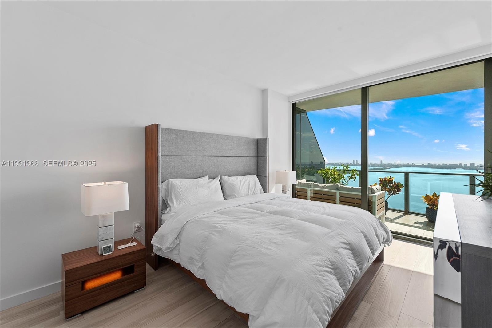 460 Northeast 28th Street, Unit 3903 Miami, FL 33137 - Photo 24 of 44 a bedroom with a bed window and lamp