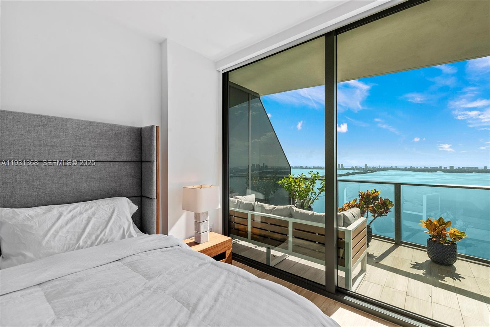 460 Northeast 28th Street, Unit 3903 Miami, FL 33137 - Photo 28 of 44 a bedroom with furniture and a floor to ceiling window