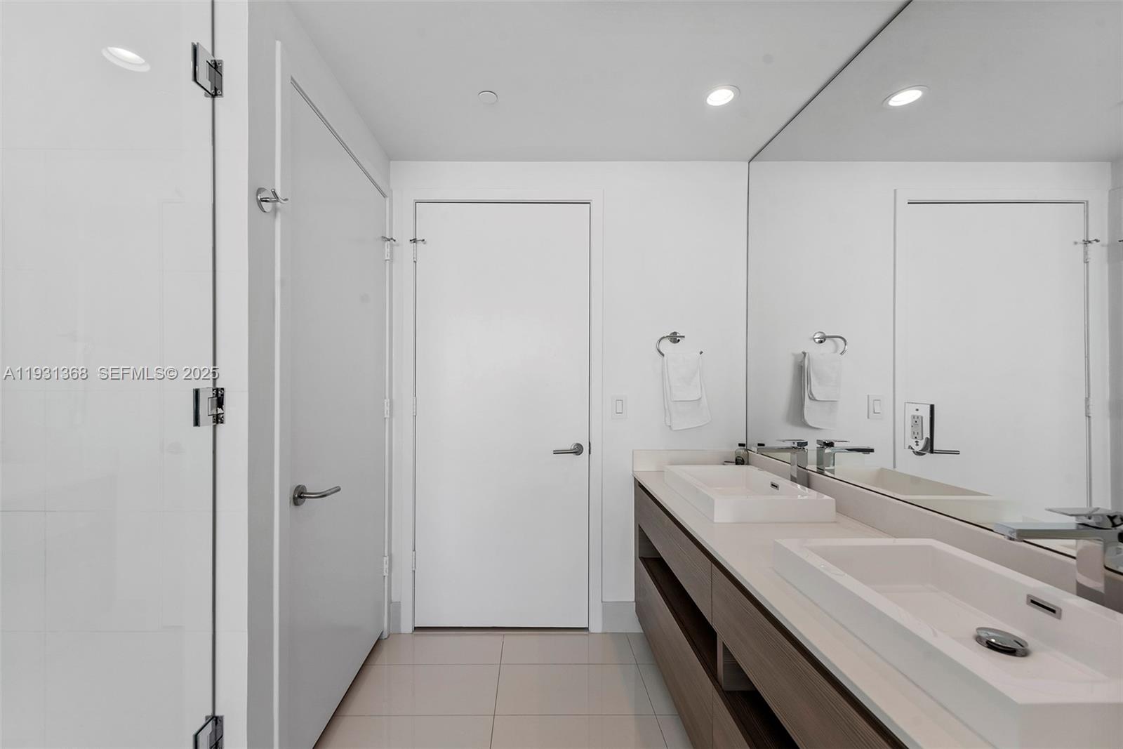 460 Northeast 28th Street, Unit 3903 Miami, FL 33137 - Photo 31 of 44 a bathroom with a double vanity sink mirror and shower