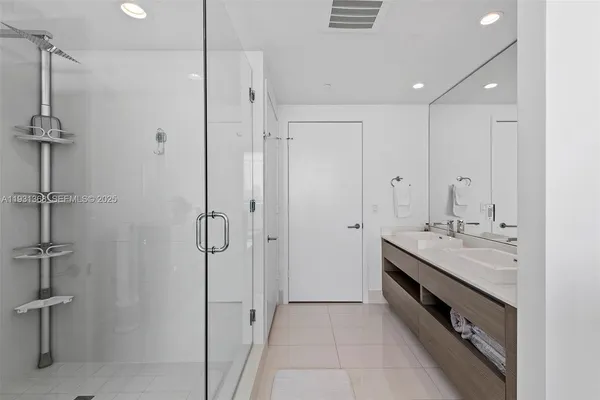 a spacious bathroom with a shower and a sink