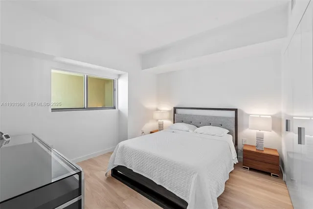 a bedroom with a bed and a night stand