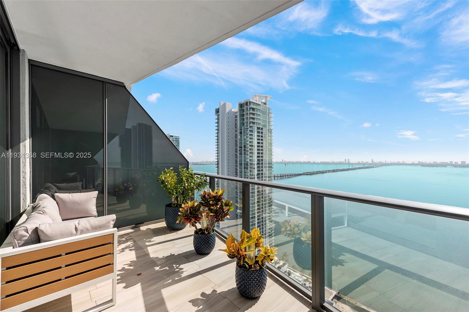 460 Northeast 28th Street, Unit 3903 Miami, FL 33137 - Photo 41 of 44 a balcony with couple of chairs and potted plants
