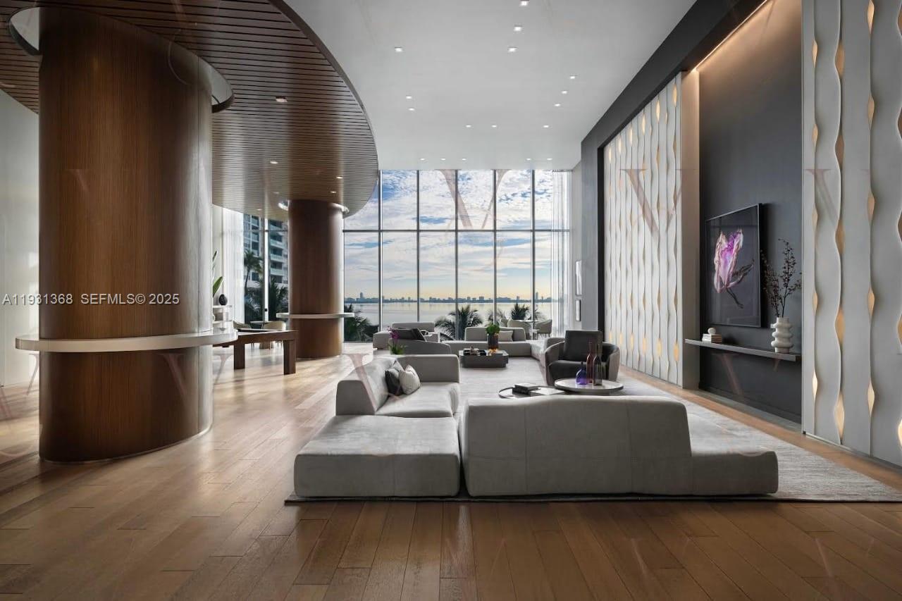 460 Northeast 28th Street, Unit 3903 Miami, FL 33137 - Photo 6 of 44 a living room with furniture wooden floor and a large window