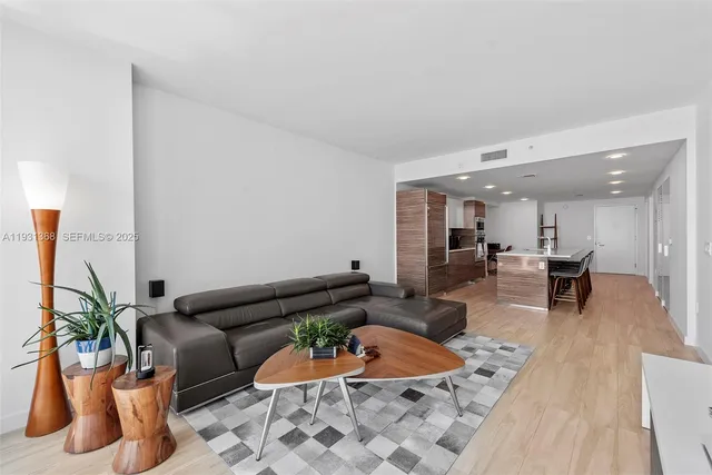 a living room with furniture and a potted plant