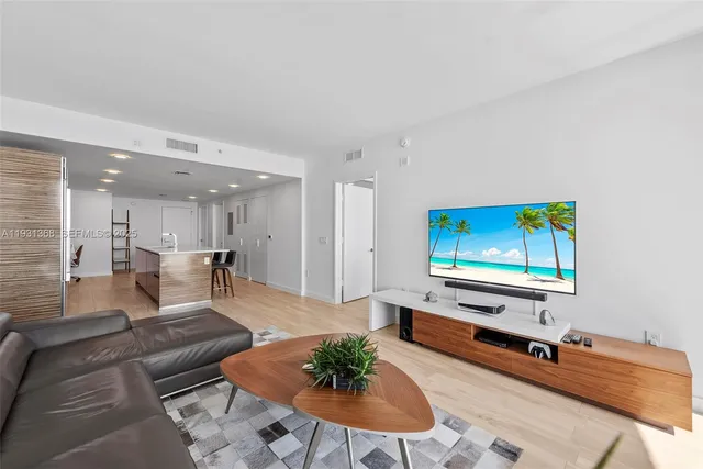 a living room with furniture pool table and a flat screen tv