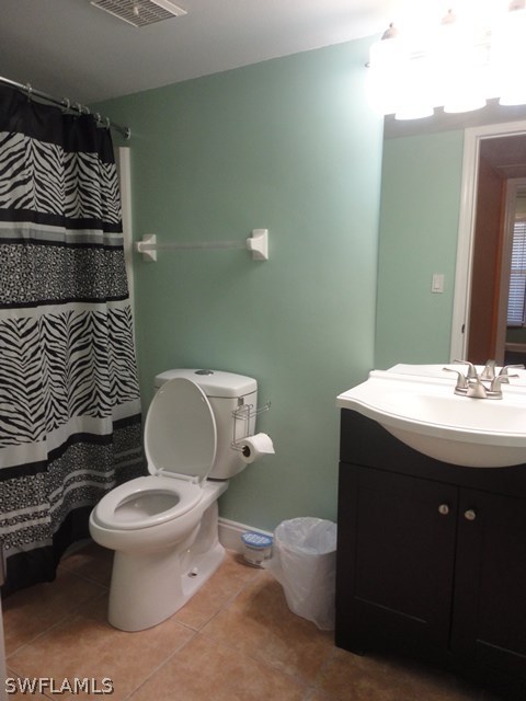 5307 Summerlin Road, Unit 710 Fort Myers, FL 33919 - Photo 11 of 19 a bathroom with a toilet a sink and mirror