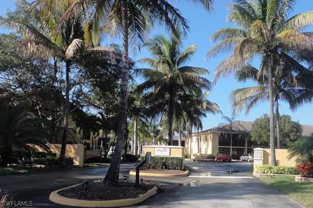 5307 Summerlin Road, Unit 710 Fort Myers, FL 33919 - Photo 19 of 19 a swimming pool with outdoor seating and trees
