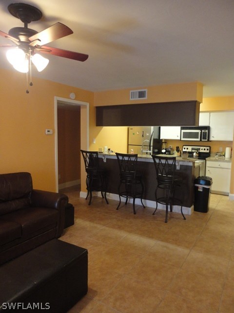5307 Summerlin Road, Unit 710 Fort Myers, FL 33919 - Photo 5 of 19 a living room with furniture and a flat screen tv