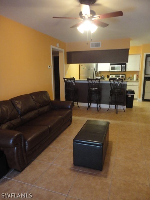 5307 Summerlin Road, Unit 710 Fort Myers, FL 33919 - Photo 6 of 19 a living room with furniture and a flat screen tv