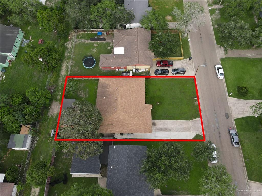 616 5th Street Weslaco, TX 78596 - Photo 13 of 33 an aerial view of a house with a yard and a large tree