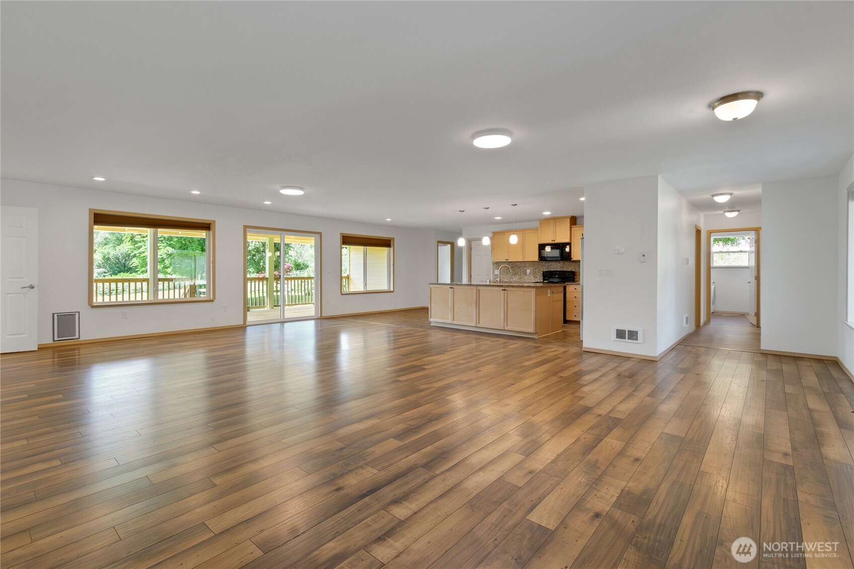 1450 Southeast Spruce Road Port Orchard, WA 98367 - Photo 3 of 39 an empty room with wooden floor and windows
