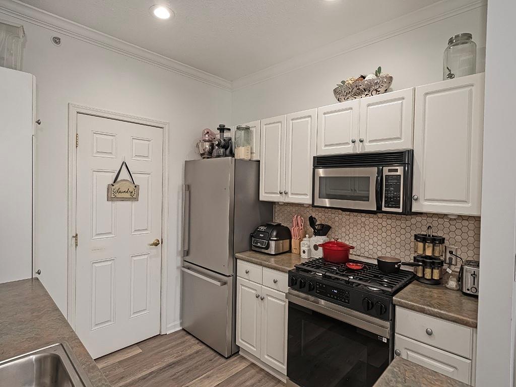 1009 Stockton Ridge Cranberry Township, PA 16066 - Photo 11 of 26 a kitchen with a refrigerator stove and white cabinets