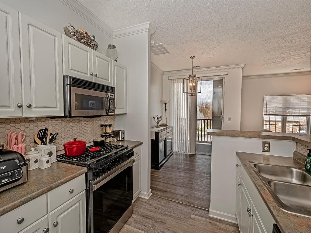 1009 Stockton Ridge Cranberry Township, PA 16066 - Photo 12 of 26 a kitchen with stainless steel appliances a sink stove and cabinets