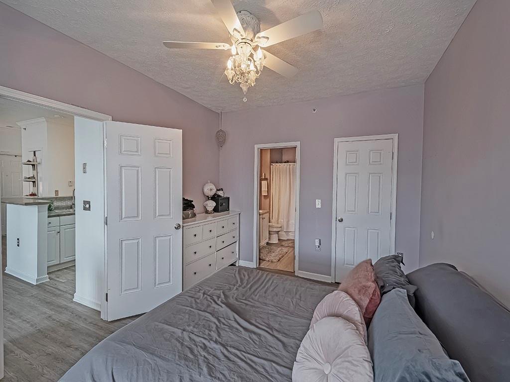 1009 Stockton Ridge Cranberry Township, PA 16066 - Photo 18 of 26 a bedroom with a bed and a chandelier