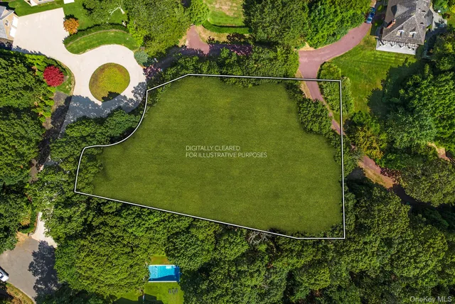 an aerial view of a residential houses with outdoor space and street view