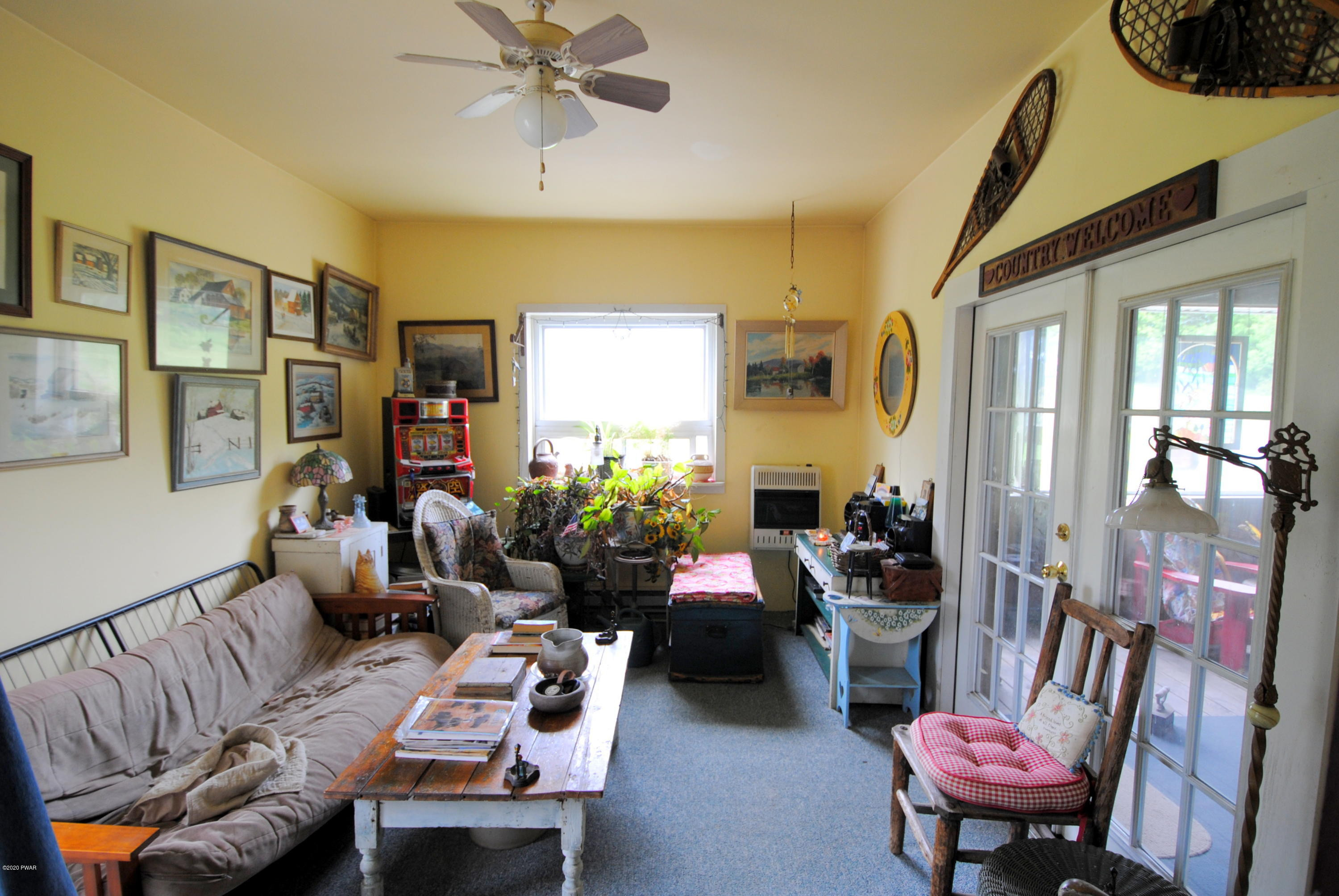 313 Old Racht Road Waymart, PA 18472 - Photo 12 of 39 a living room with furniture fireplace and a large window
